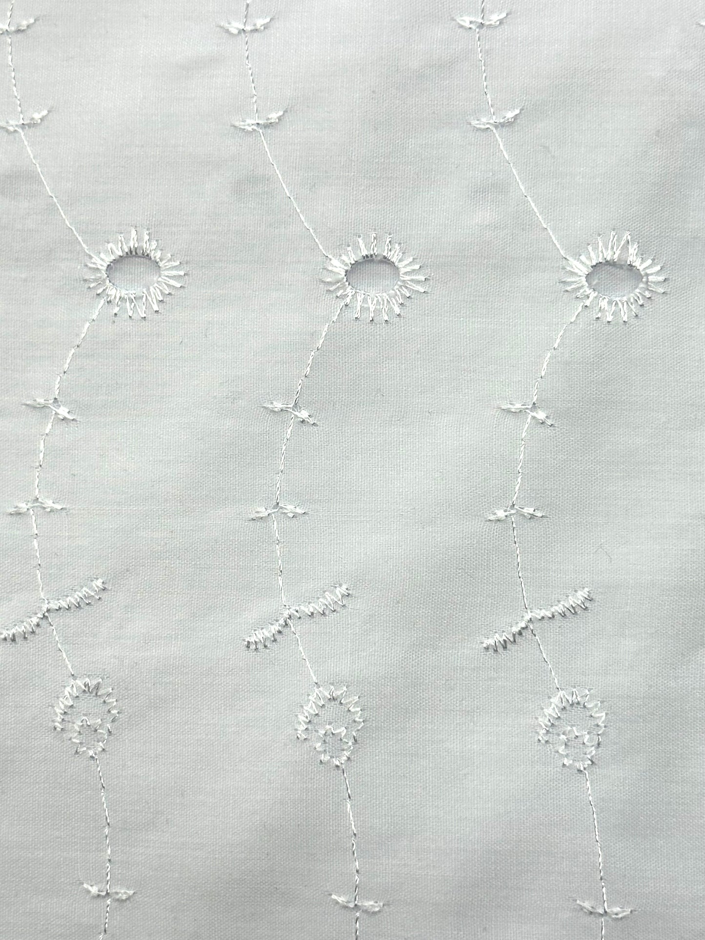 The Eyelet Tie by Square Up Fashions features white poly cotton fabric with subtle shiny white embroidery—vertical lines connected by circular floral shapes. Enjoy easy returns for a hassle-free shopping experience.