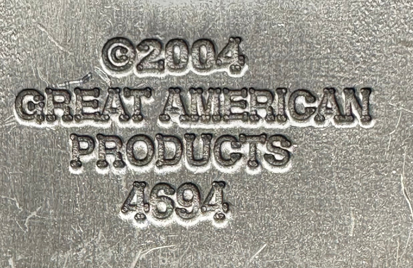 Embossed metal text on this Music Note Belt Buckle by Square Up Fashions reads: ©2004 GREAT AMERICAN PRODUCTS 4694, making it a unique collectible musical accessory.