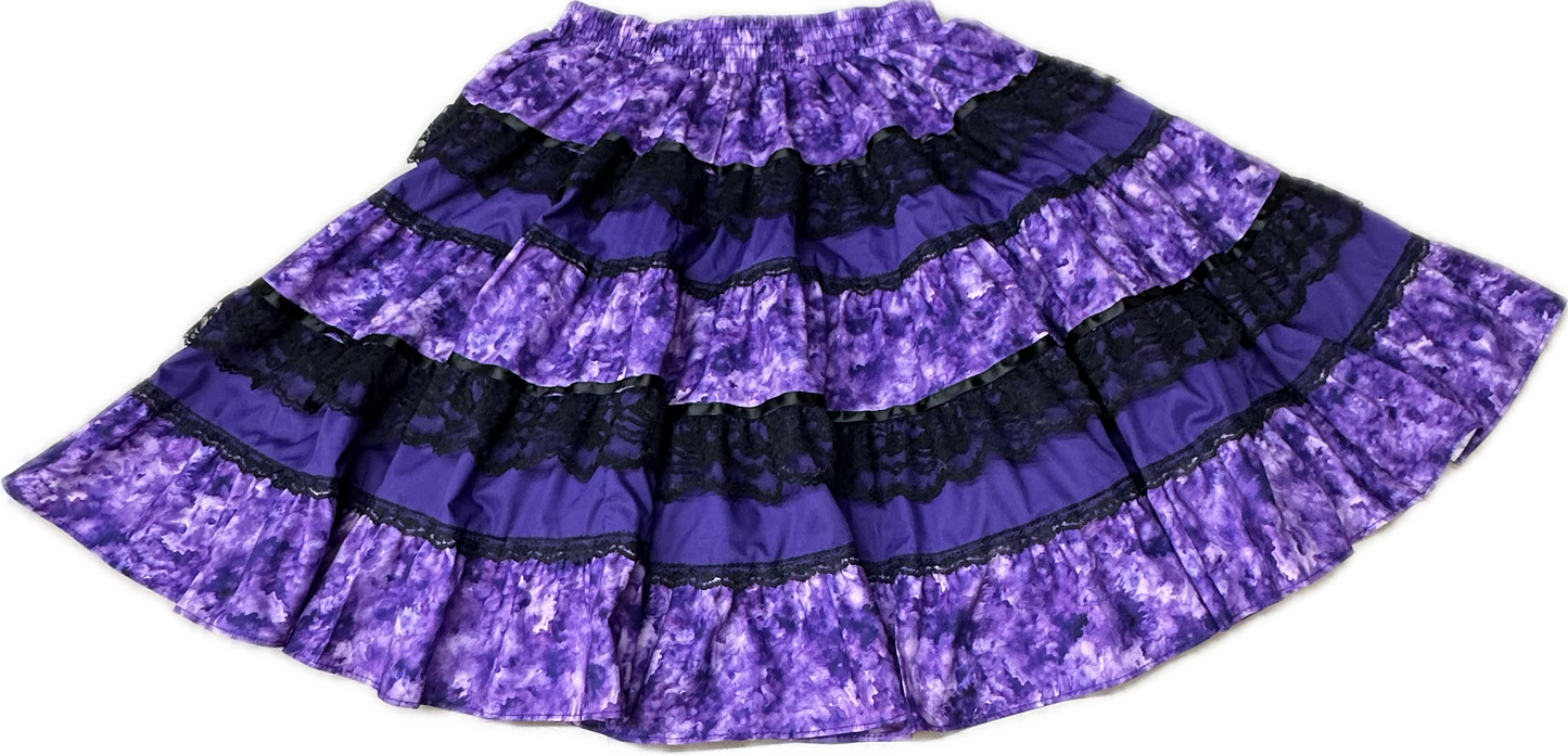 The Square Up Fashions Tone on Tone Square Dance Skirt is a five-tiered purple skirt with black lace trim and an elastic waistband, shown flat on a white background—an ideal piece for any women’s wardrobe.