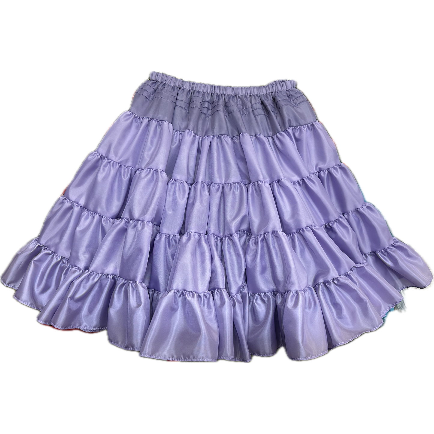 The Soft Poly-Liner Petticoat by Square Up Fashions is a lavender, knee-length skirt with ruffled tiers and an elastic waistband—ideal as a petticoat or for square dancing.