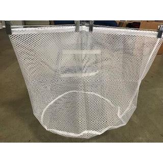 A white Square Up Fashions Petticoat Storage Bag with a drawstring closure sitting on a table in a warehouse.