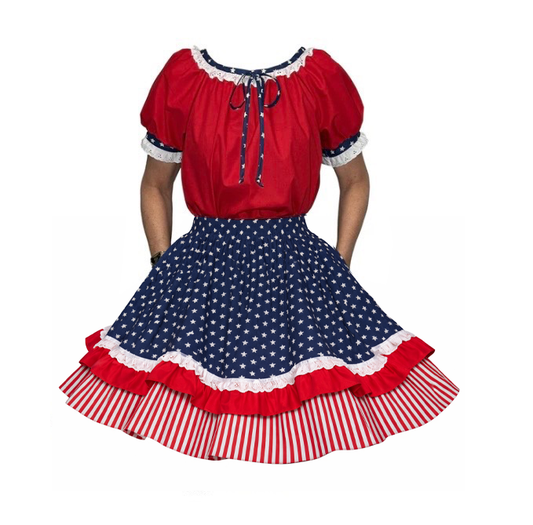 Wearing the Patriotic Spirit 250th Anniversary Outfit by Square Up Fashions—a red top with puffed sleeves and a blue skirt adorned with white stars, red ruffles, and striped hem—makes for a perfect Independence Day look.