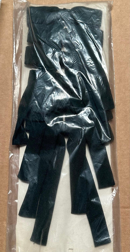 A package of Colonel Ties by Square Up Fashions, consisting of several black plastic strips resembling southern bow ties, neatly stacked inside a clear plastic wrapping.