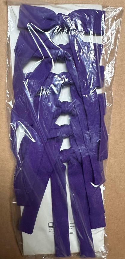 A package containing multiple fabric straps in a purple hue, reminiscent of vintage western styles, neatly folded inside a clear plastic wrapper, known as "Colonel Ties" by Square Up Fashions.