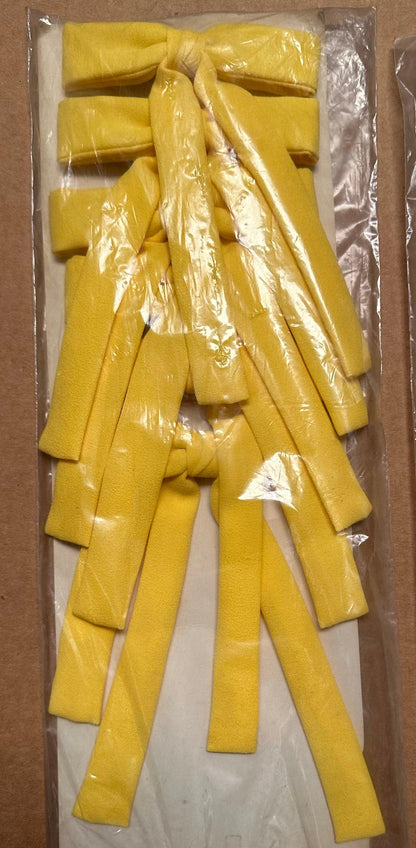 Seven Colonel Ties in yellow, featuring a southern bow tie style, stacked and wrapped in clear plastic packaging by Square Up Fashions.