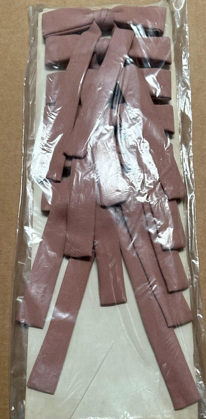 A package of Colonel Ties by Square Up Fashions contains several long, thin, brown strips crafted from a material that closely resembles leather, making them perfect for achieving that classic western look.