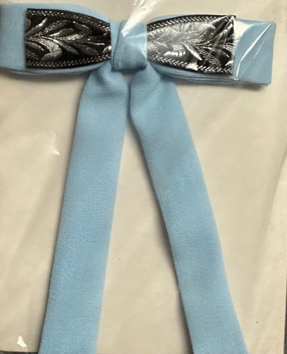 A soft Colonel Ties bow from Square Up Fashions, featuring a light blue fabric with metallic silver leaf accents at the center, evokes the charm of a southern bow tie against a simple backdrop.