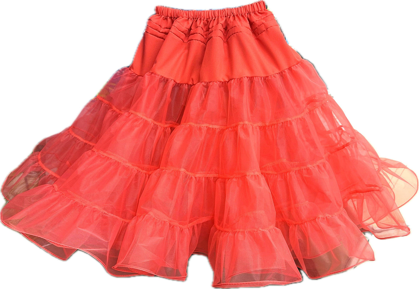 The Square Up Fashions Organdy Stiff Petticoat is a coral pink, double-layered tiered tulle petticoat with an elastic waistband, designed to add volume under skirts or dresses.
