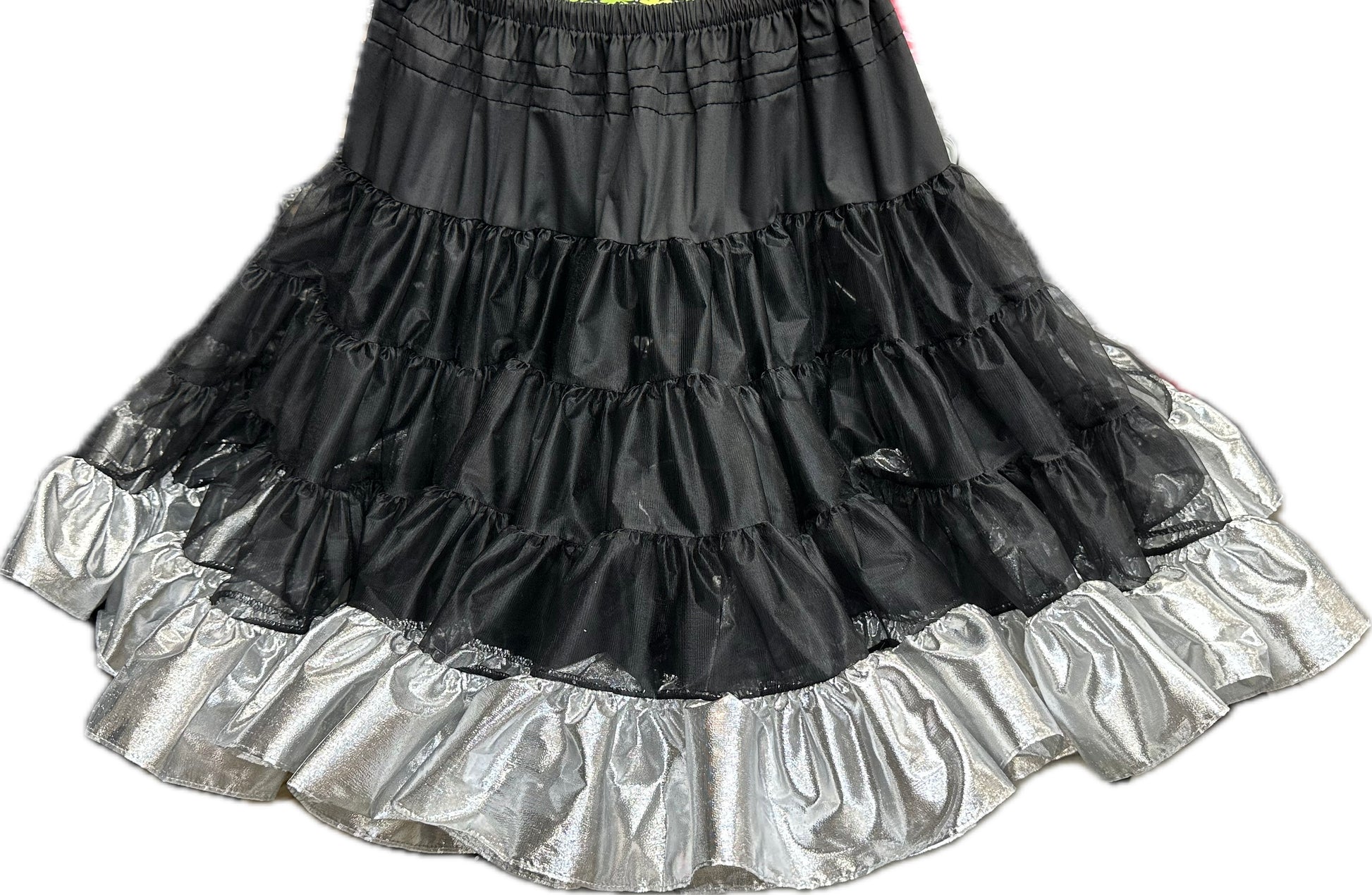 The Square Up Fashions Combo Metallic Petticoat (60 yard) features black tissue lame tiers with a shiny silver ruffle hem, ideal as a petticoat or for square dance costumes. Shown on a white background.