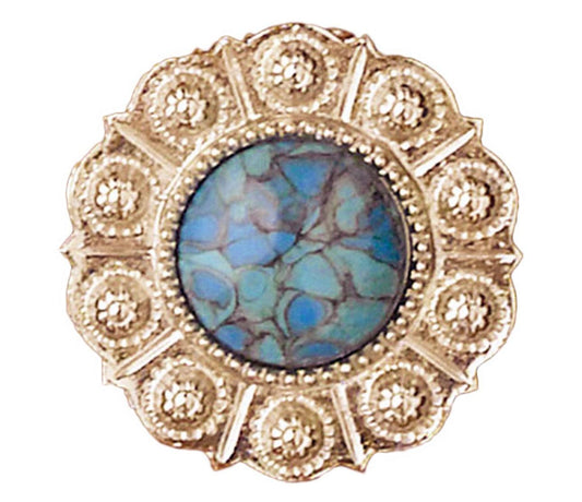 The Western Express Turquoise Scarf Slide with Scalloped Silver Edge is a circular silver-plated gold brooch with a blue-green marbled stone in the center, surrounded by intricate gold detailing and small circular patterns. Made in USA, this stunning accessory measures 1.25" in diameter.