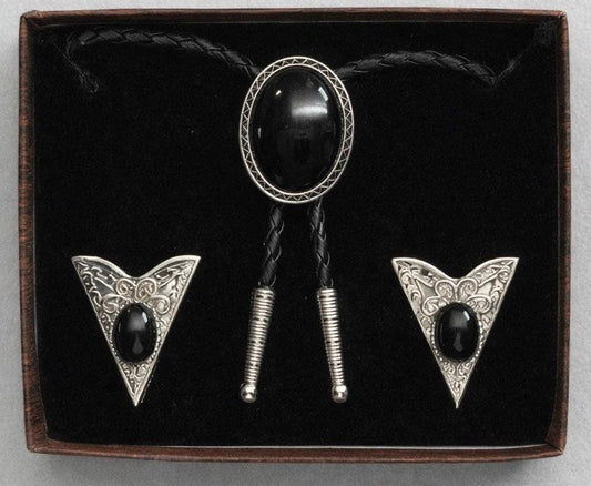 The Western Express Black Stone Bolo Tie & Collar Tip Set features silver plating and black oval stones with engraved designs, presented in a velvet-lined box. Made in the USA.