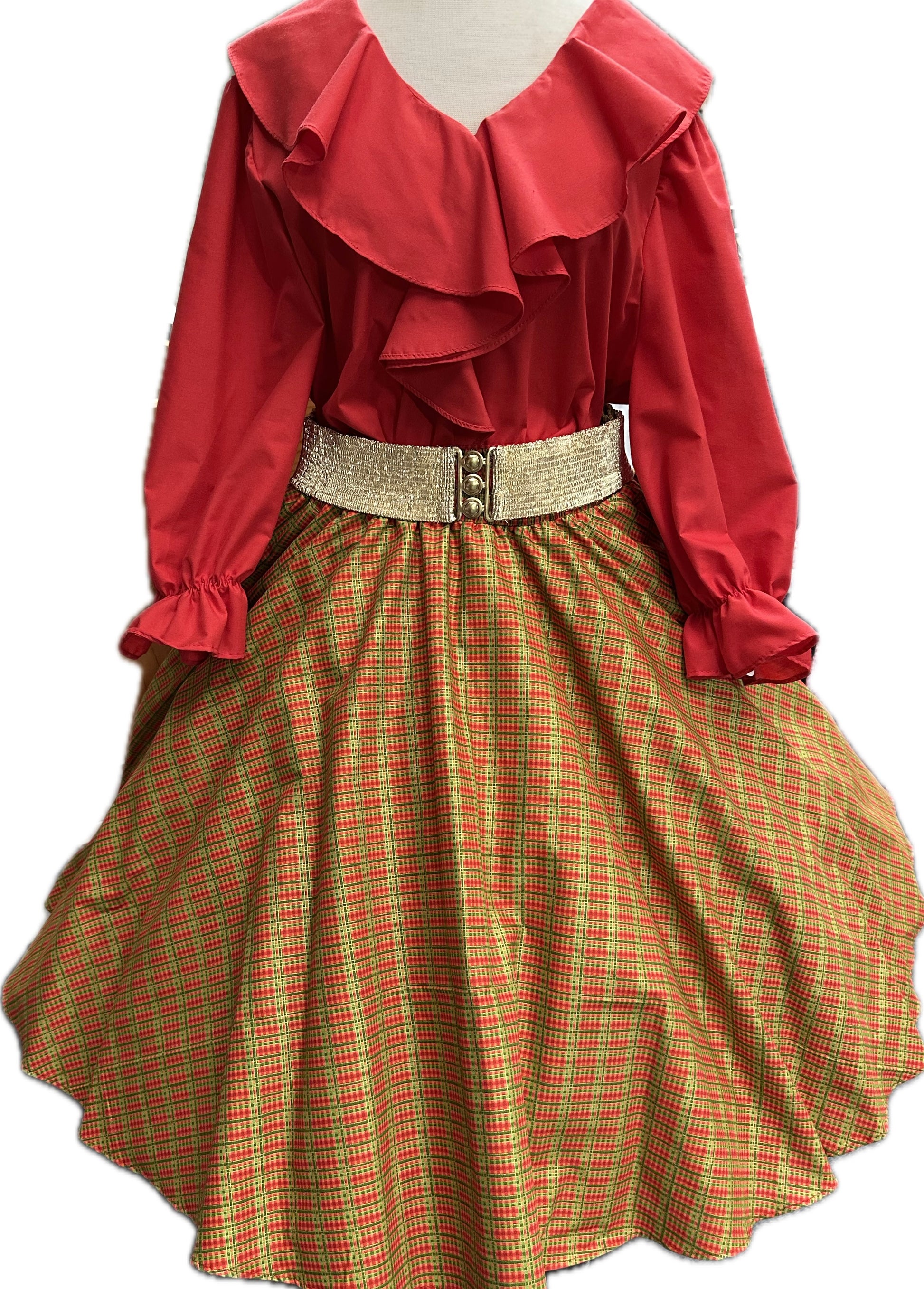 A red ruffled long-sleeve blouse is paired with Square Up Fashions' Plaid Christmas Skirt with POCKETS in yellow and red tartan, finished with a wide gold belt, and displayed on a dress form.
