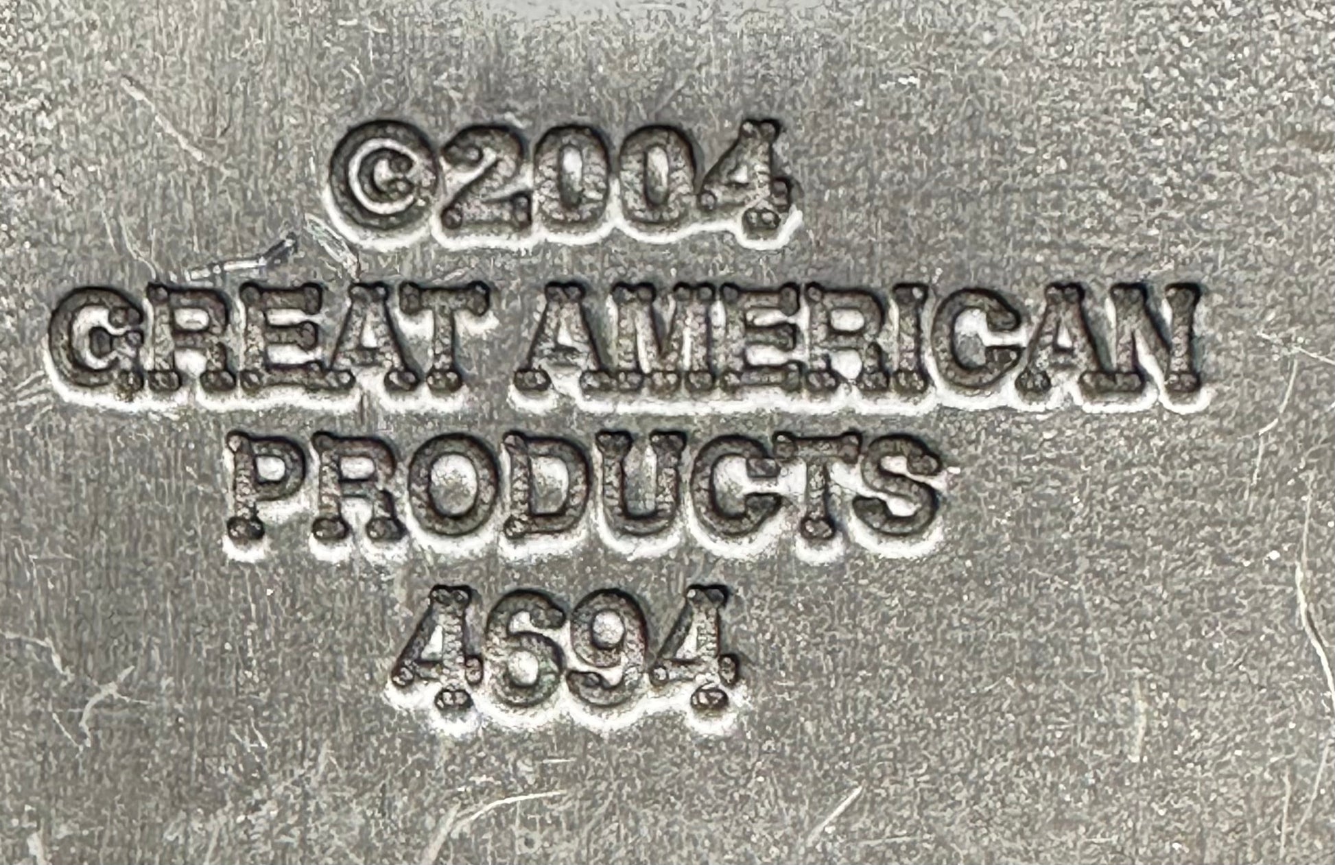 Embossed metal text on this Music Note Belt Buckle by Square Up Fashions reads: ©2004 GREAT AMERICAN PRODUCTS 4694, making it a unique collectible musical accessory.