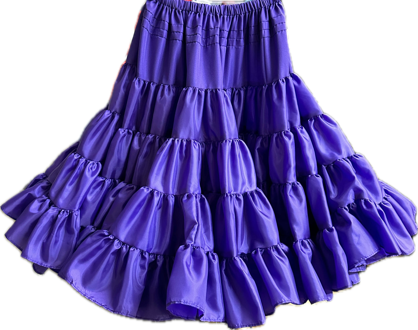 A tiered, ruffled skirt in bright purple fabric with the Square Up Fashions Soft Poly-Liner Petticoat underneath, shown from the waist down.