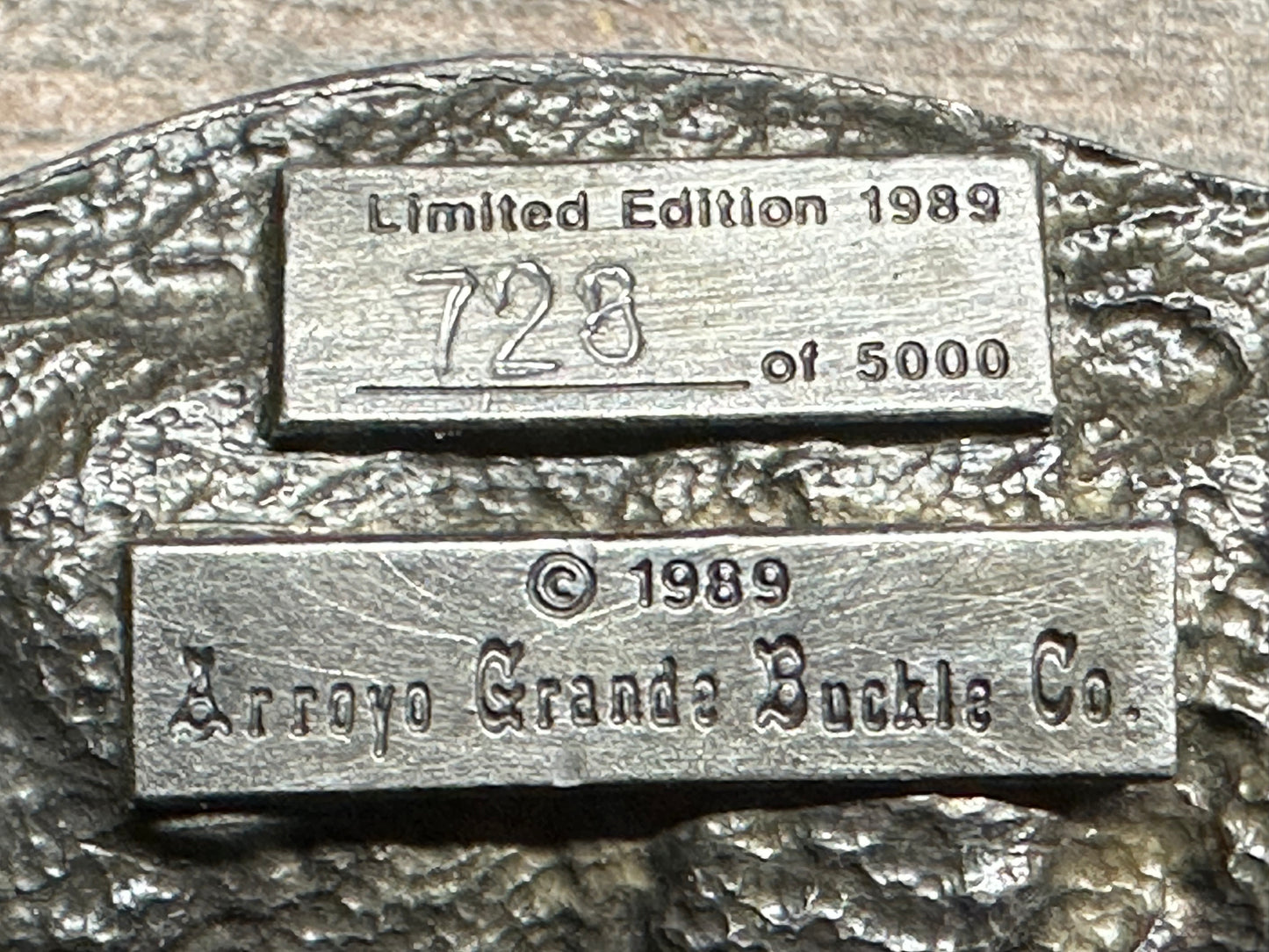 A close-up of the Square Up Fashions Square Dance Buckle w/caller shows "Limited Edition 1989, 728 of 5000" and "© 1989 Arroyo Grande Buckle Co." engraved on textured metal—a true USA-made commemorative from 1989.