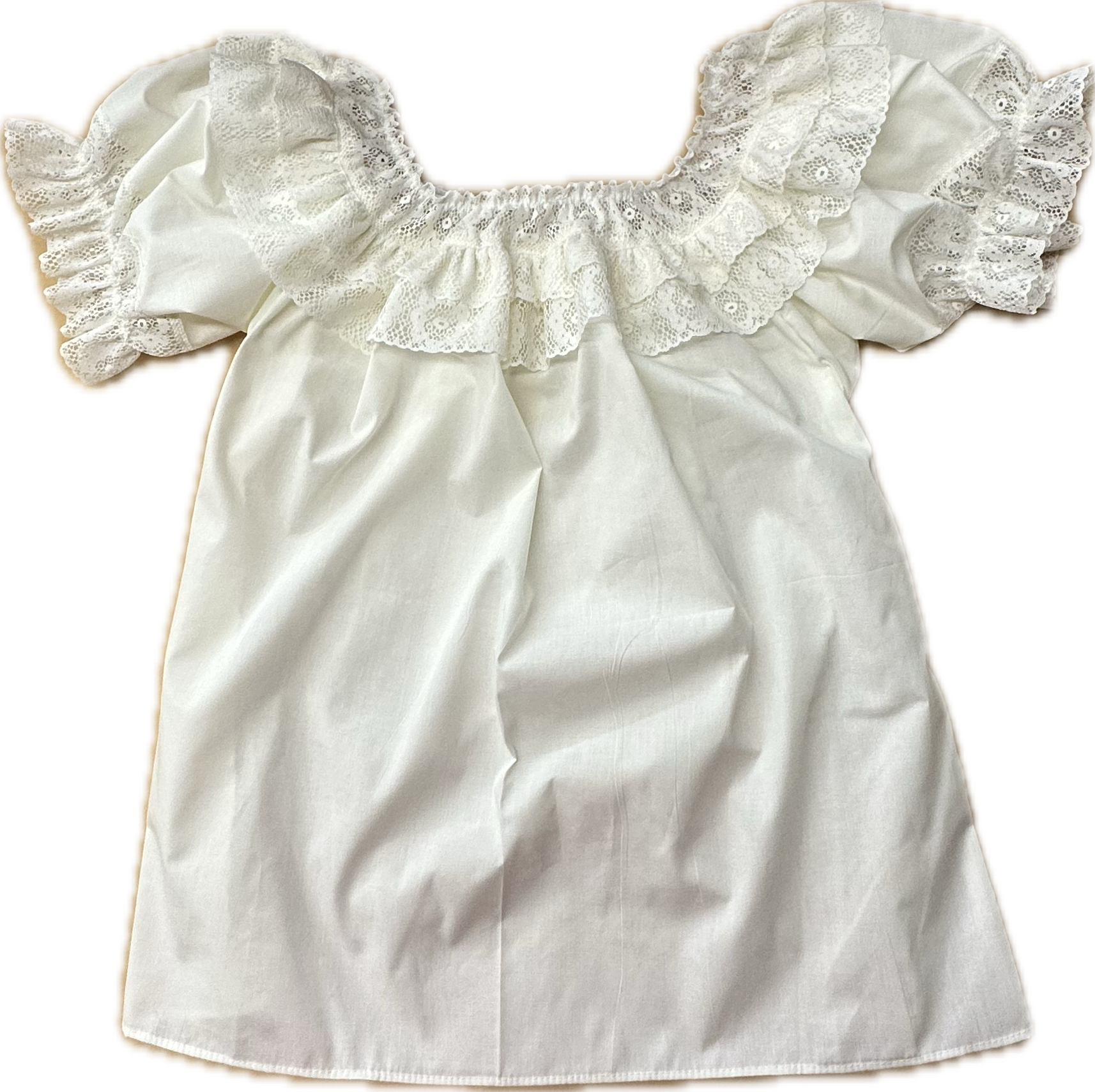 The Fiesta Laced Round Neck Blouse by Square Up Fashions features white cotton, short ruffled fiesta lace sleeves, and a delicate lace ruffle at the neckline, shown laid flat on a plain background.