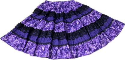 The Square Up Fashions Tone on Tone Square Dance Skirt is a five-tiered purple skirt with black lace trim and an elastic waistband, shown flat on a white background—an ideal piece for any women’s wardrobe.