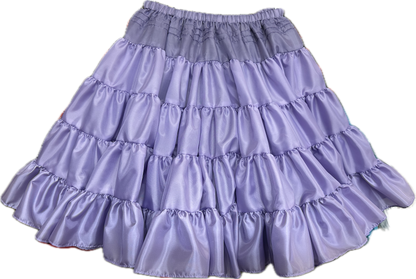 The Soft Poly-Liner Petticoat by Square Up Fashions is a lavender, knee-length skirt with ruffled tiers and an elastic waistband—ideal as a petticoat or for square dancing.