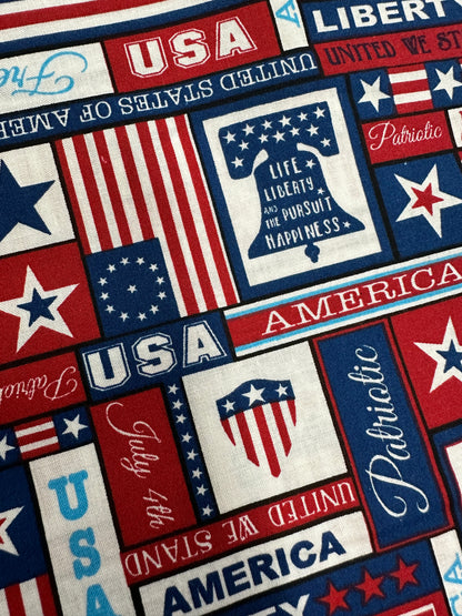 A fabric pattern perfect for a patriotic ensemble, featuring themes with words like "USA," "America," "Liberty," and "Patriotic." Includes various designs of stars, stripes, and flags in red, white, and blue colors—ideal for creating a festive July 4th Outfit from Square Up Fashions.