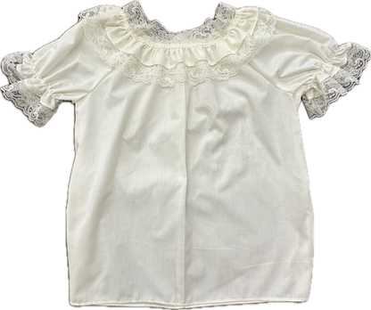 The Basic Laced Blouse by Square Up Fashions is a frilly lace garment with white short sleeves, exquisite lace detailing around the neckline, and elastic sleeves for added comfort.